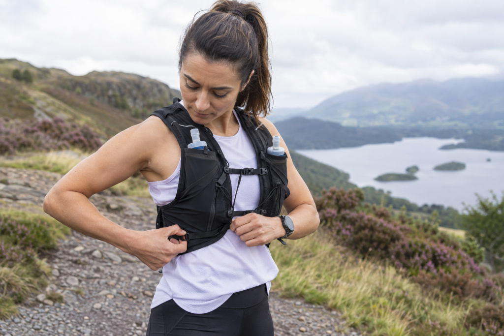 Runner adjusting the straps of a hydration vest
