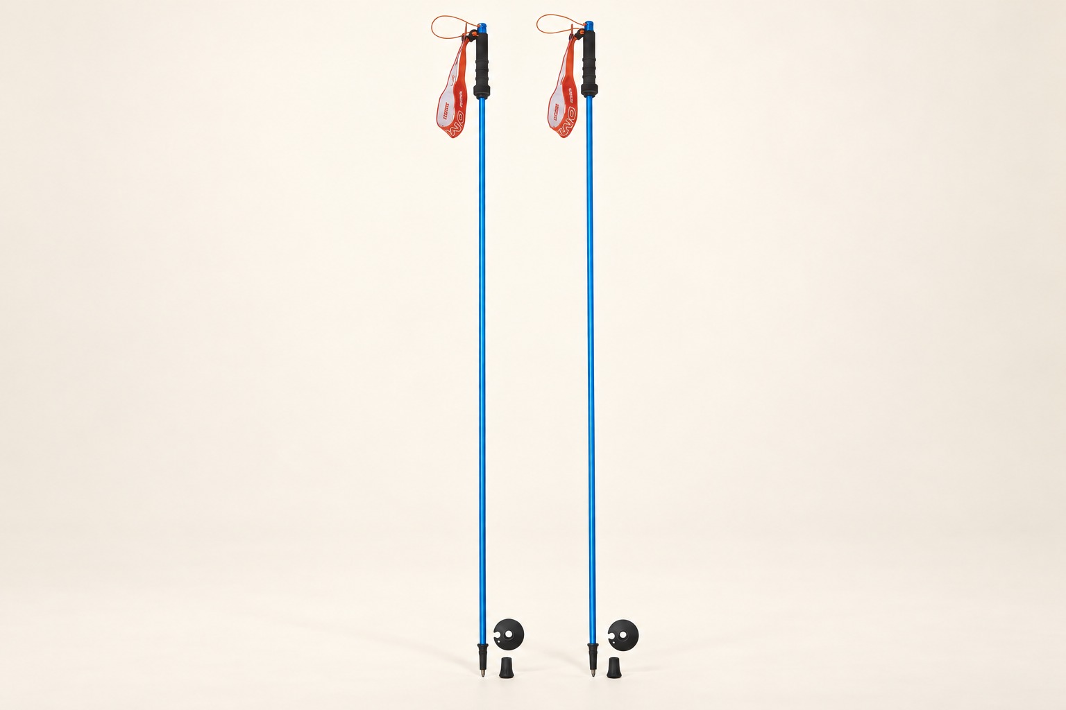 Product illustration of blue OMM Z Lite alloy poles, red straps and separate baskets