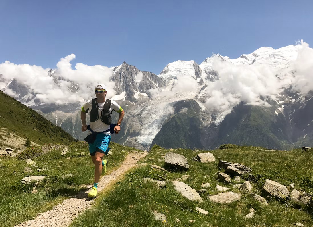 Runner wearing a hydration vest on a mountain trail